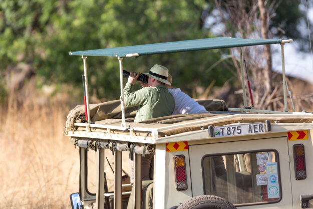 Tourists enjoying a game drive in the Serengeti National Park, the oldest national park in Tanzania, Africa.